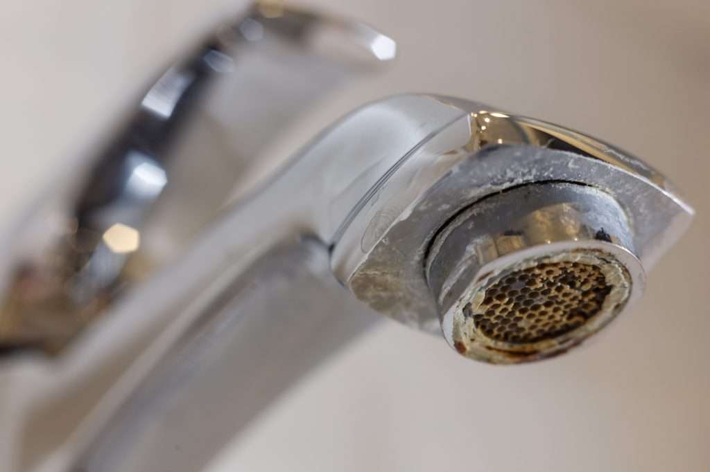 Limescale on faucet mesh in bathrooms.